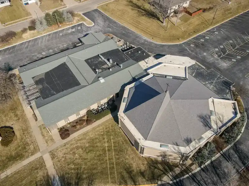 Aerial view of a church campus flat roof replacement in Omaha, NE by Royalty Roofing