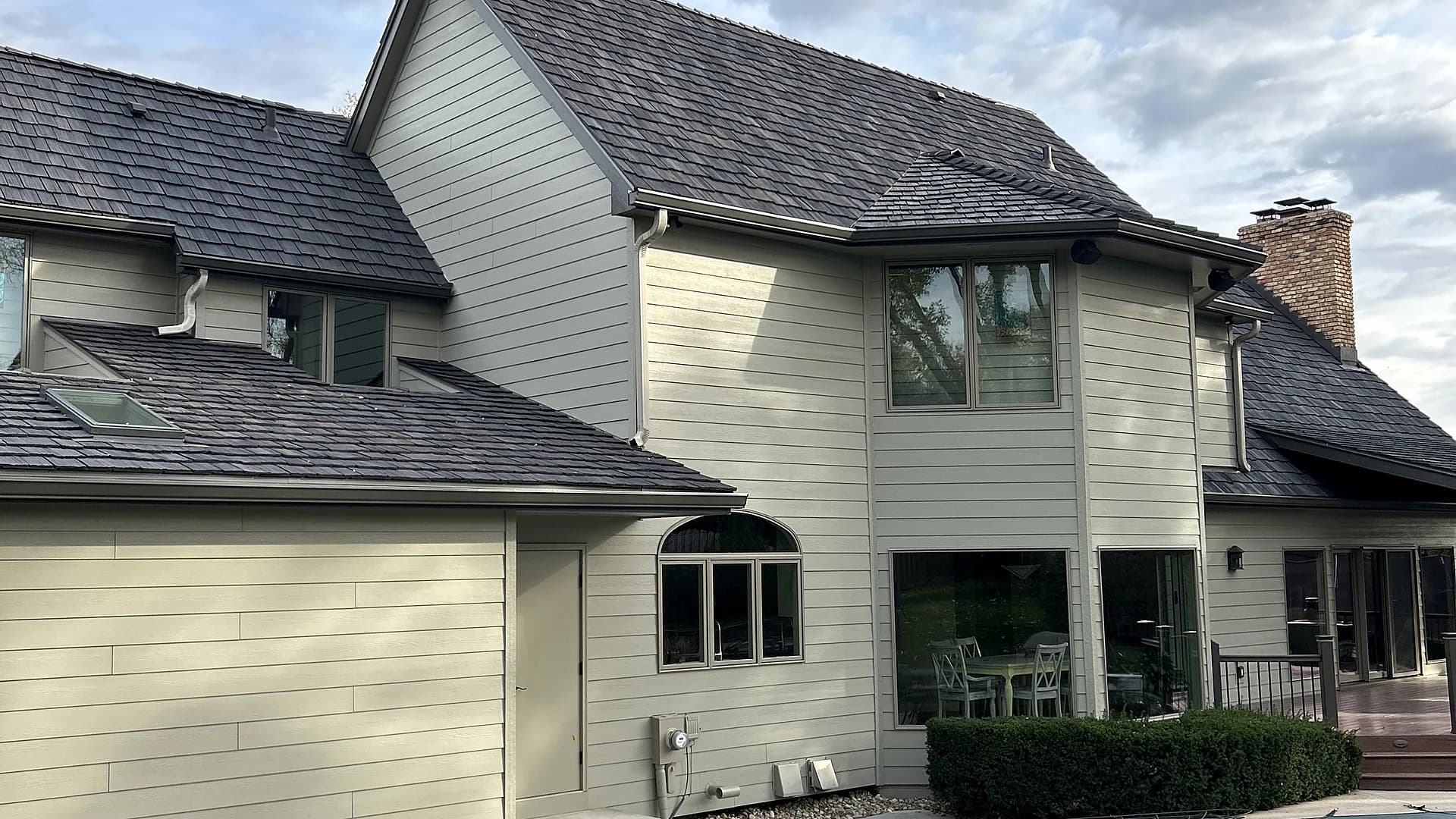 Home exterior showing replacement windows by Royalty Roofing