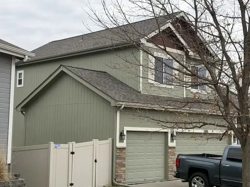Sage green board-and-batten siding on a two-story home
