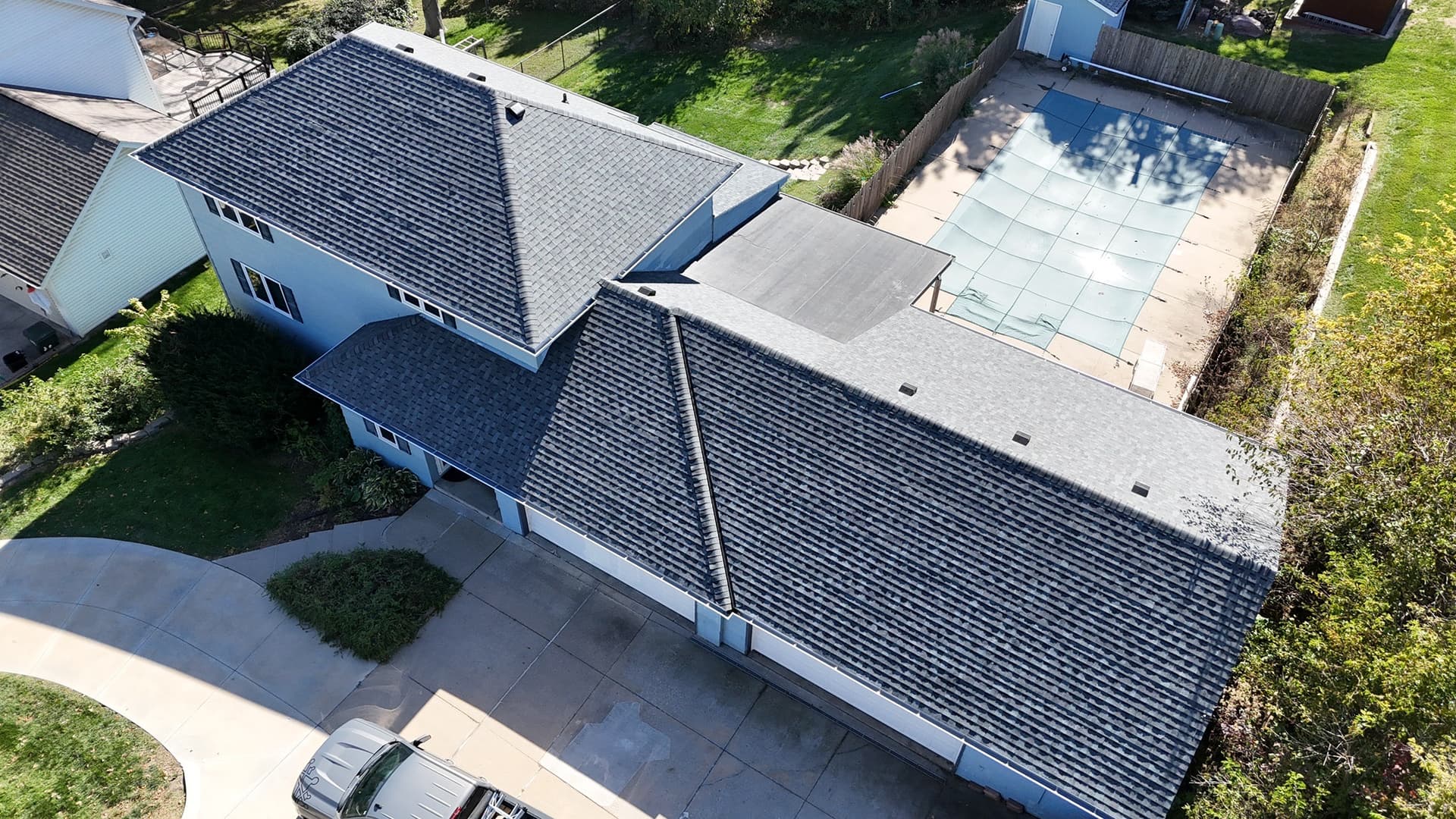 Aerial view of Omaha neighborhood with new asphalt shingle roofs installed by Royalty Roofing