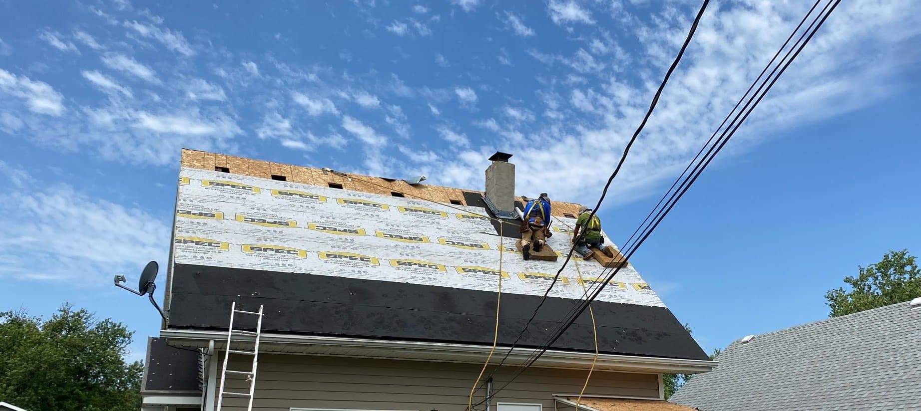 Royalty Roofing crew installing synthetic underlayment and ridge vent openings on an Omaha home