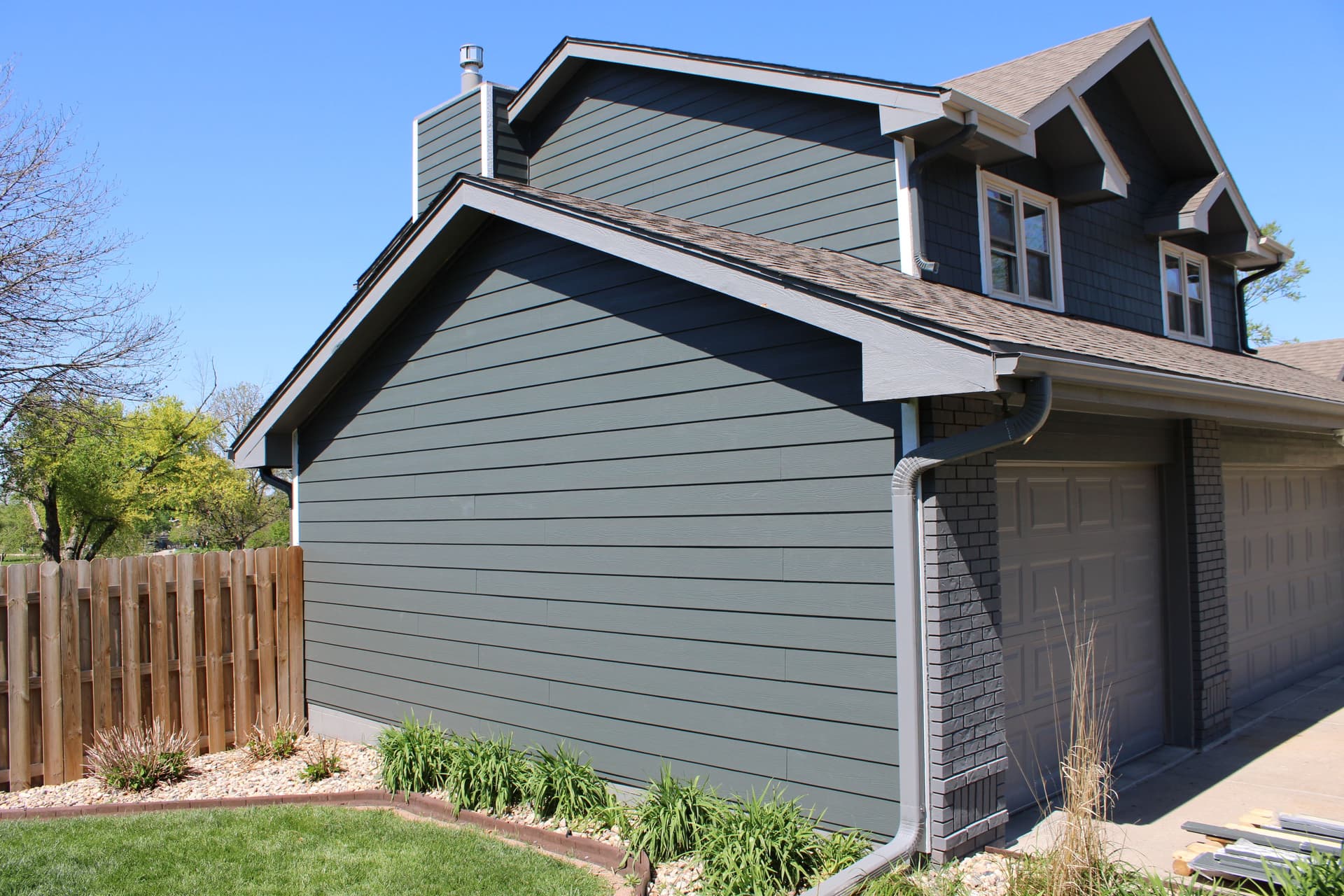 Royalty Roofing project manager documenting siding damage for insurance claim in Omaha