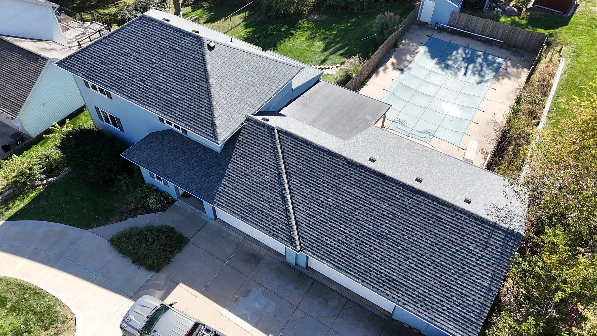 Aerial view of Omaha neighborhood with new asphalt shingle roofs installed by Royalty Roofing