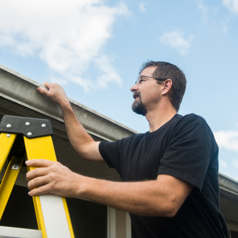man looking at gutters